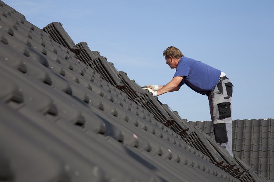 roofer working hard on roof